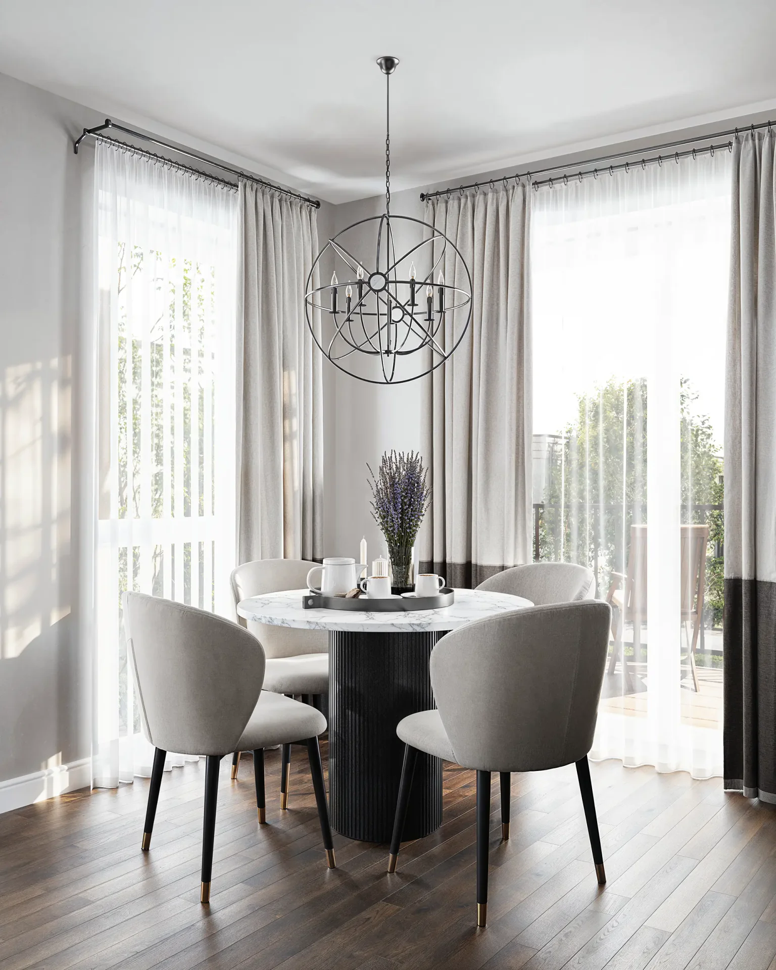Bright dining area with round marble table and modern orb chandelier.