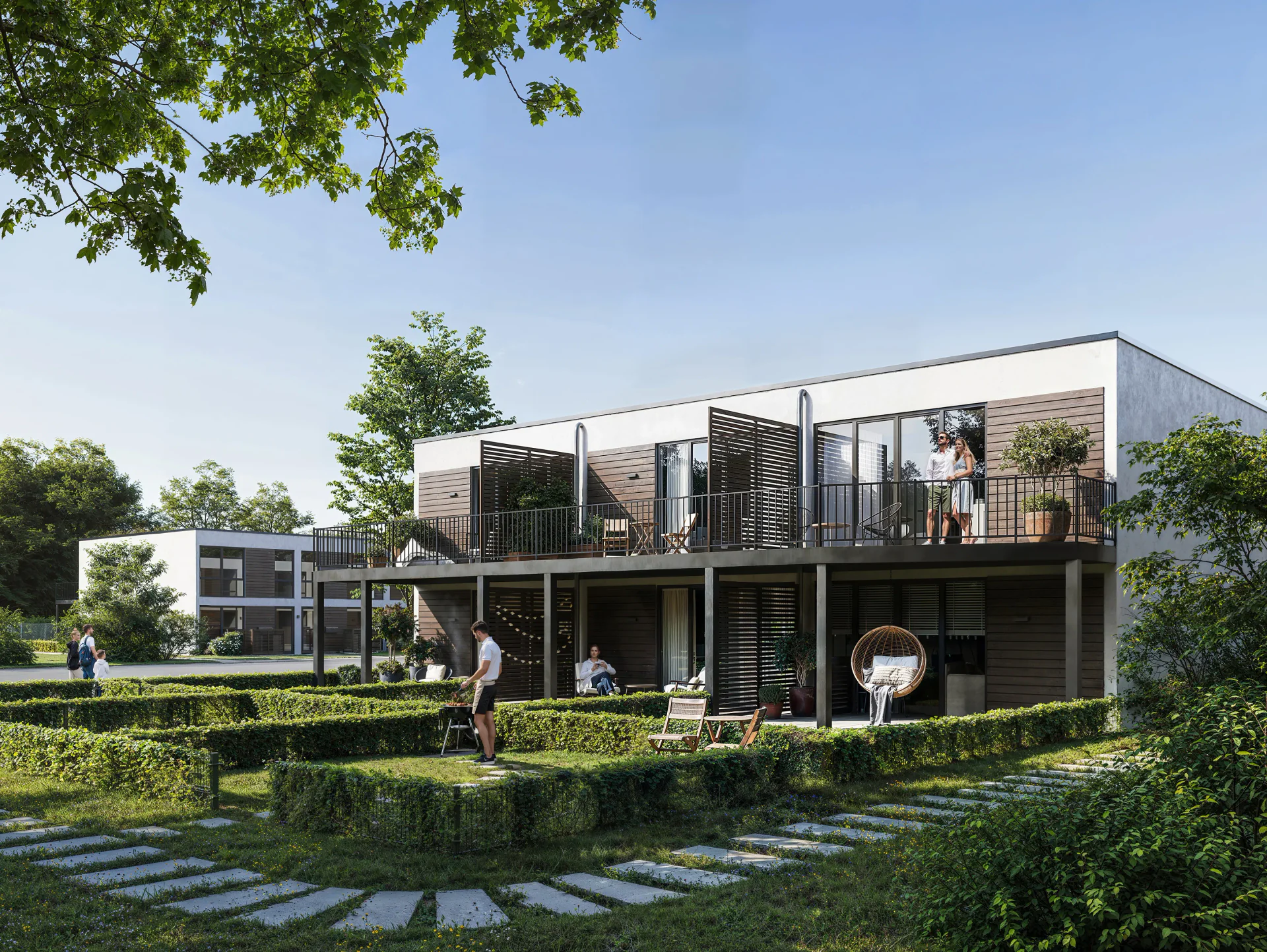 Sunny day view of a house with residents on balconies.