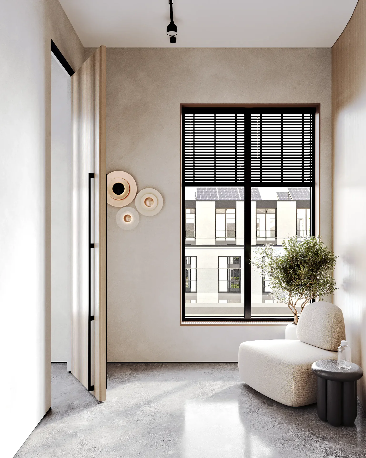 Cozy waiting nook by a window with an armchair and coffee table, near the restroom entrance.