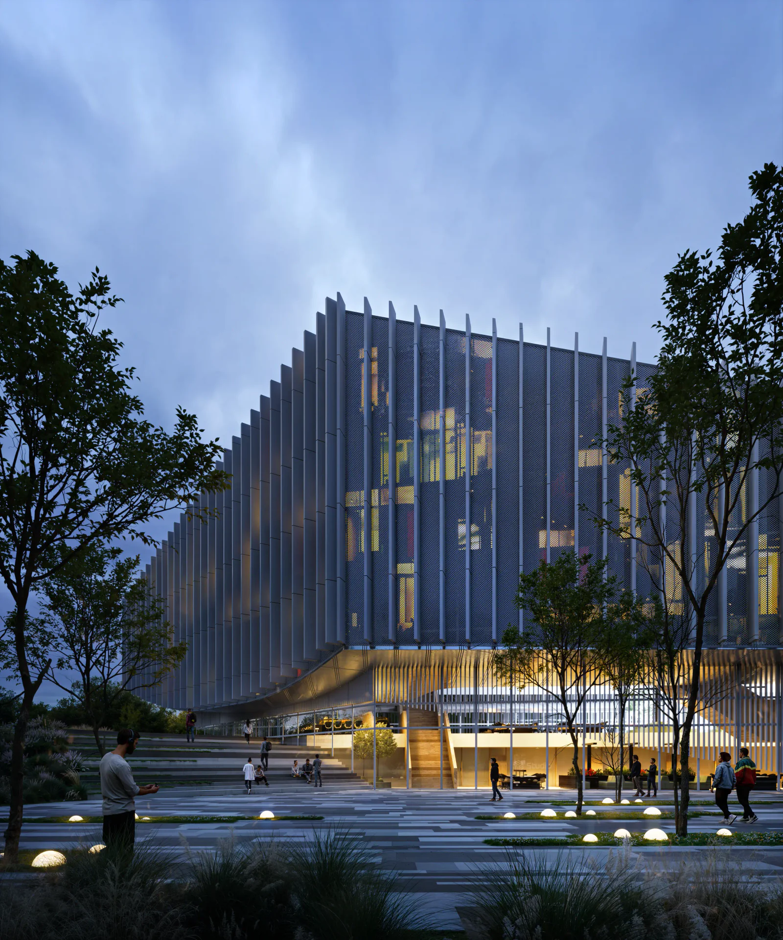 Striking evening view of the illuminated cultural center, highlighting its architectural lighting and public plaza with people.