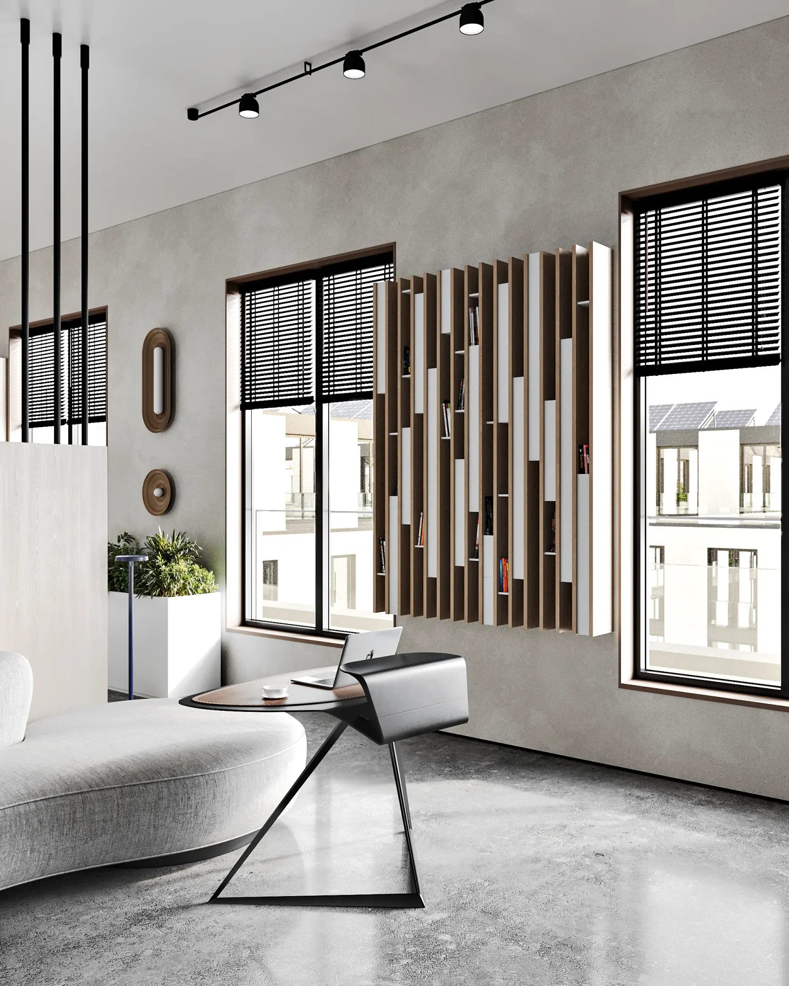 Bright breakout area with a sofa, coffee table, and wall-mounted shelving between windows.