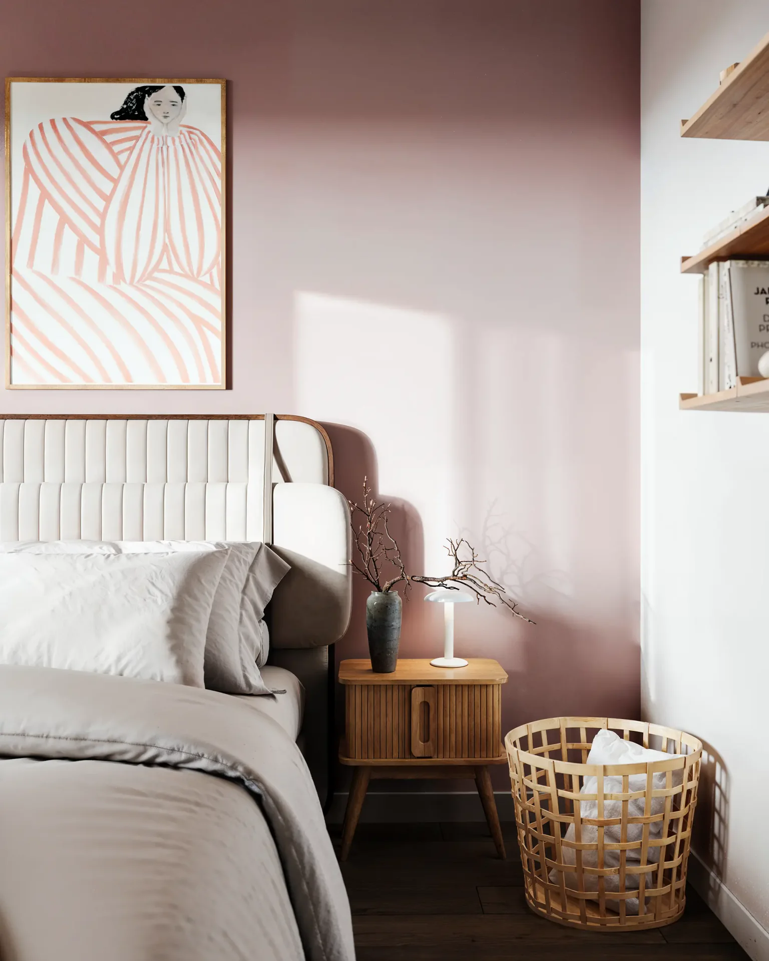 Bed headboard, bedside table with decor, and laundry basket.