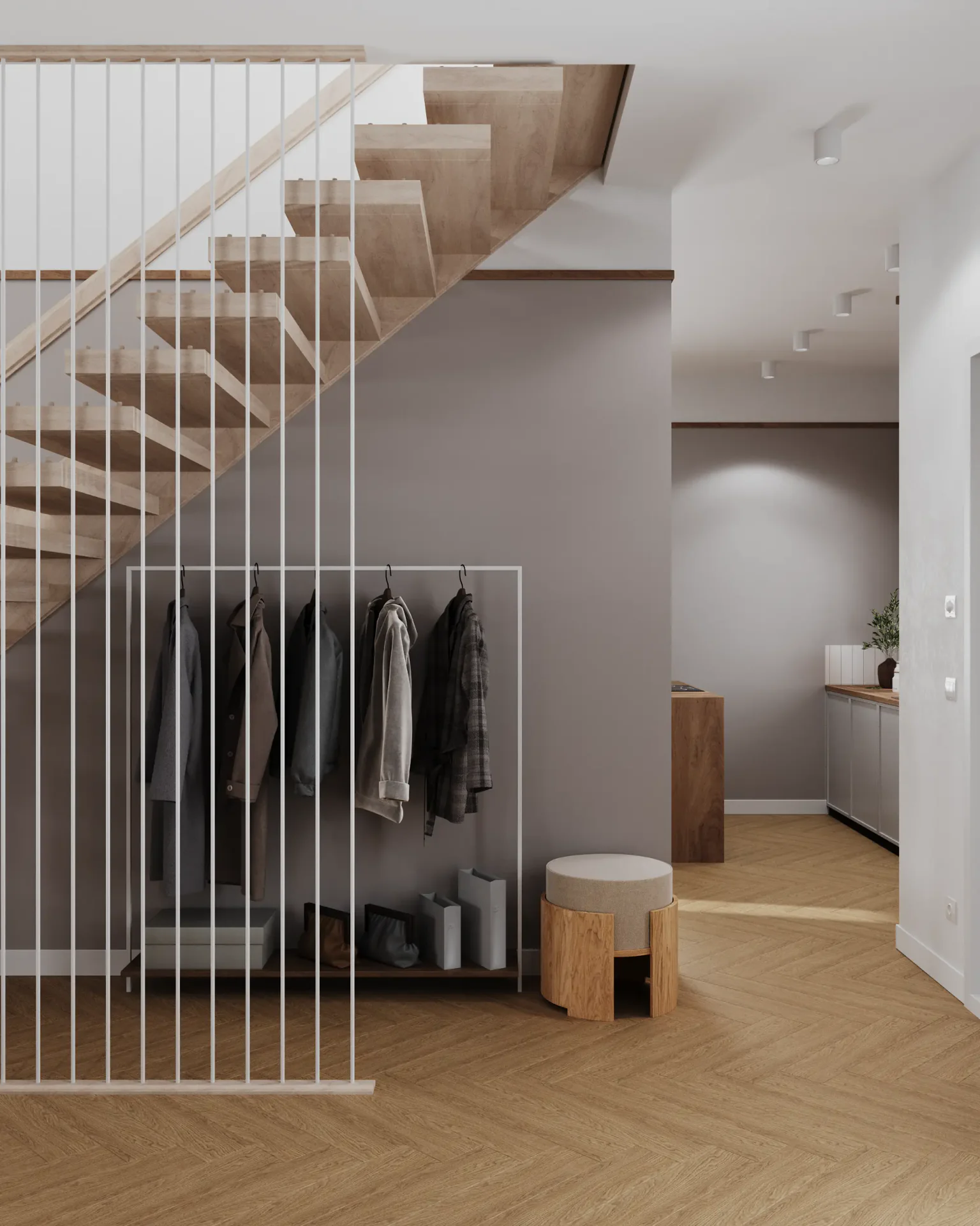 View of a staircase, coat rack, pouf, and kitchen passage.