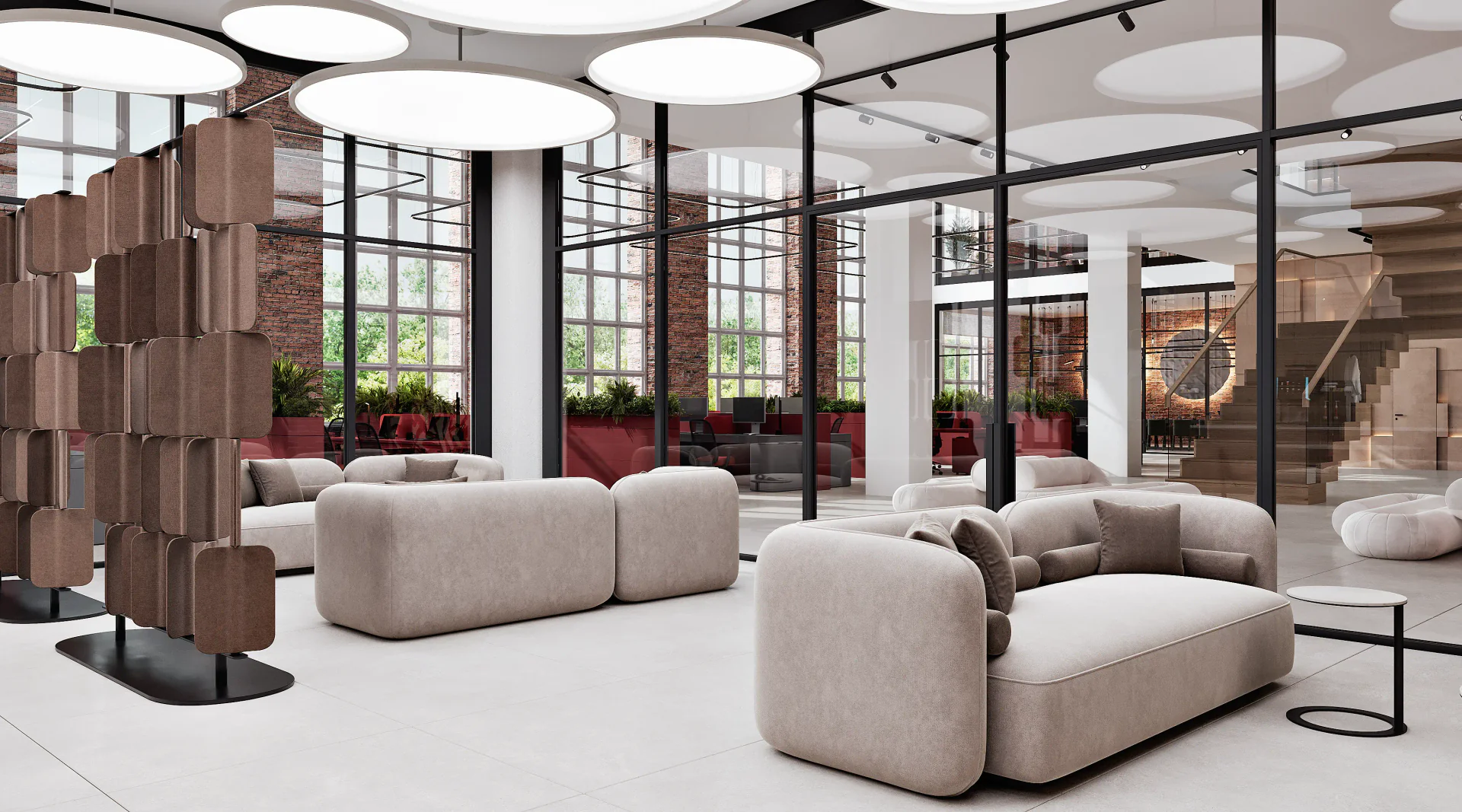 Modern office lounge area with seating, overlooking the workspace and staircase.