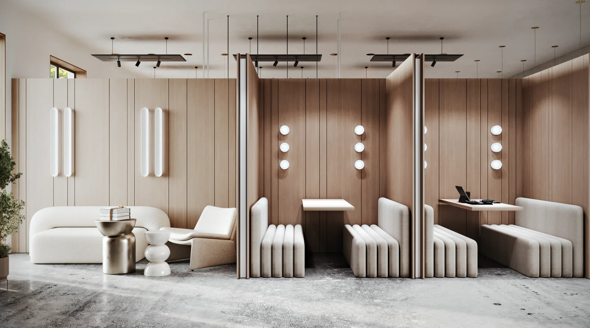 Semi-private meeting pods with wood partitions and a main lounge area with a sofa and armchair.