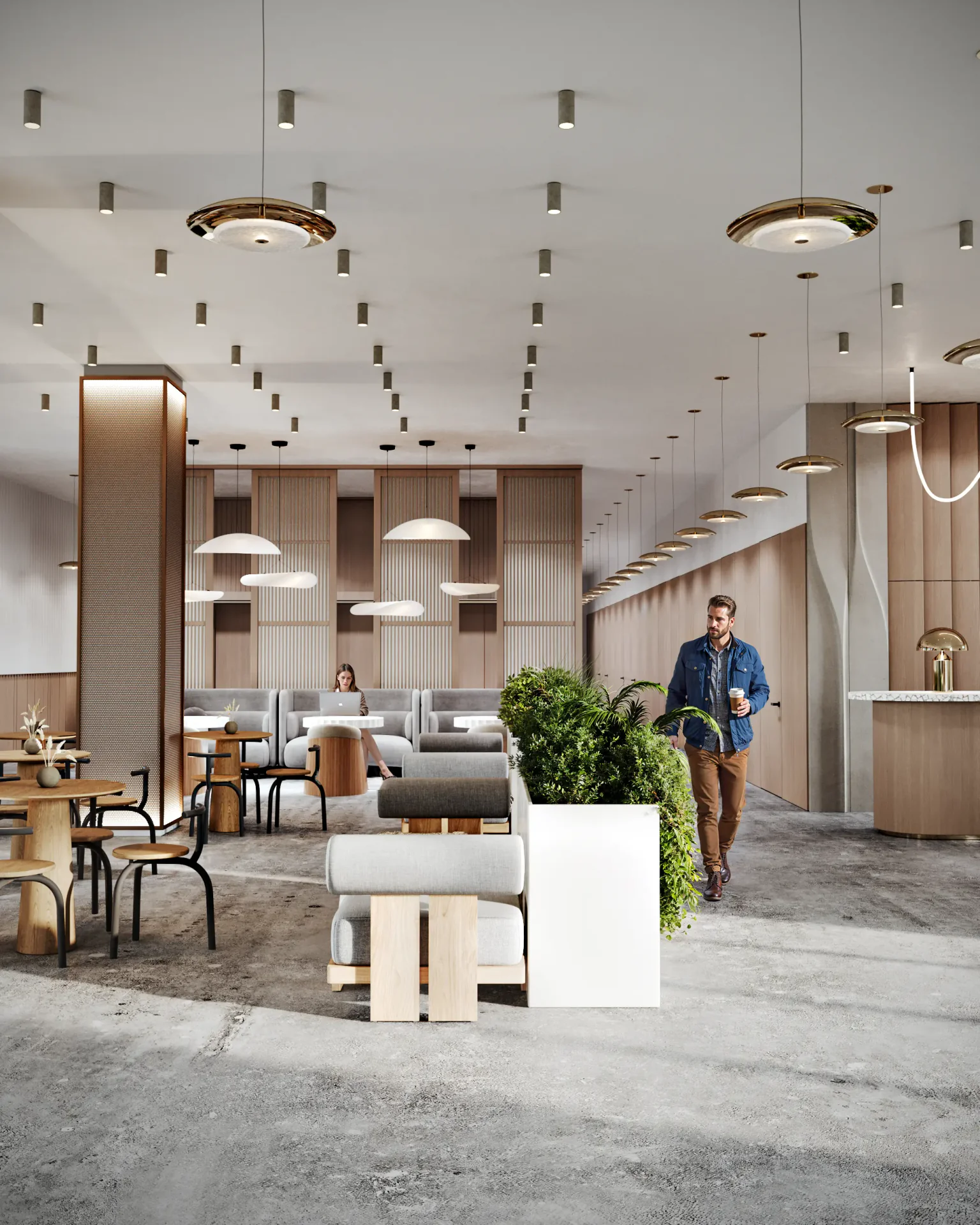 Active lobby scene showing a woman working in the cafe and a man walking by the elevator bank.