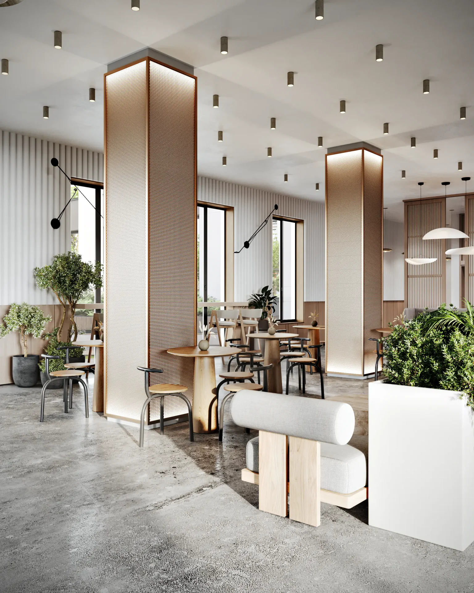 Open cafe area with group tables set among modern, structural columns in a spacious lobby.