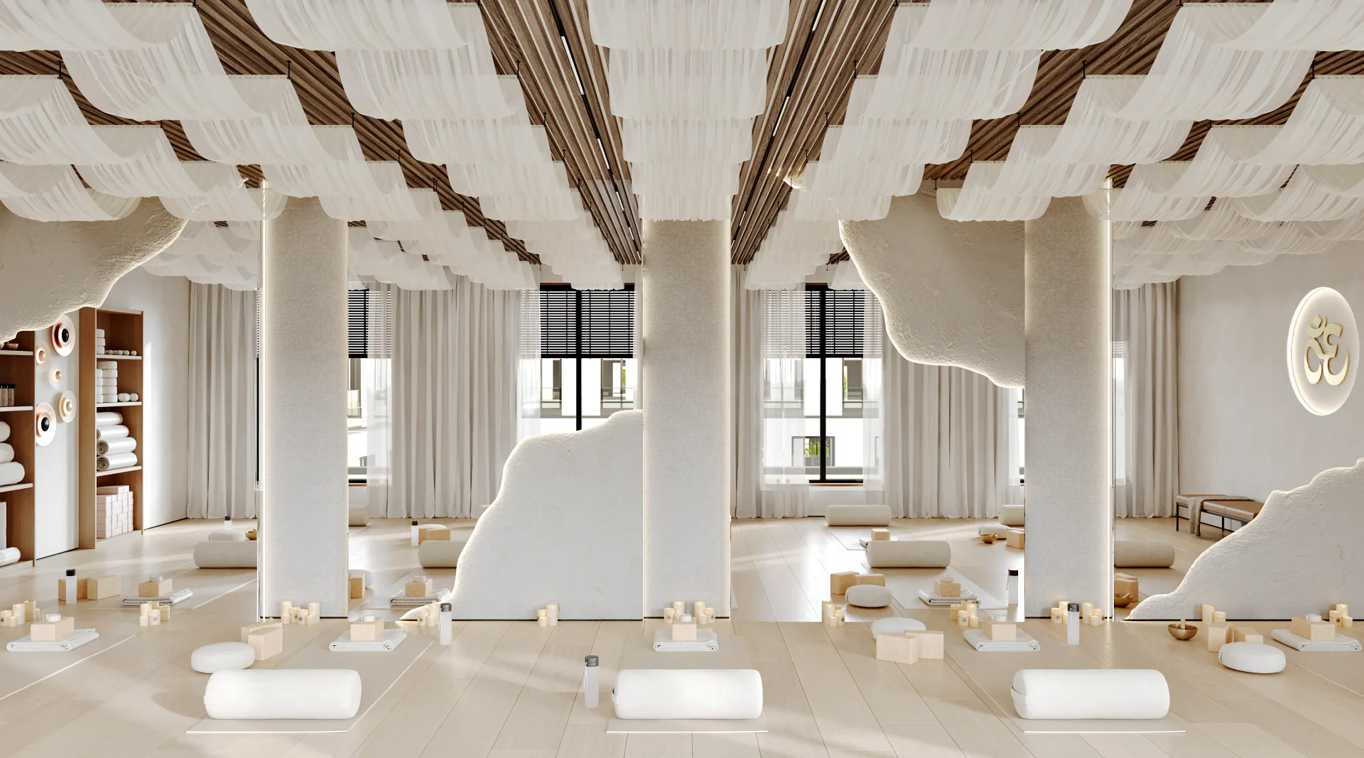 Bright yoga studio with yoga mats neatly arranged in front of a full mirrored wall.