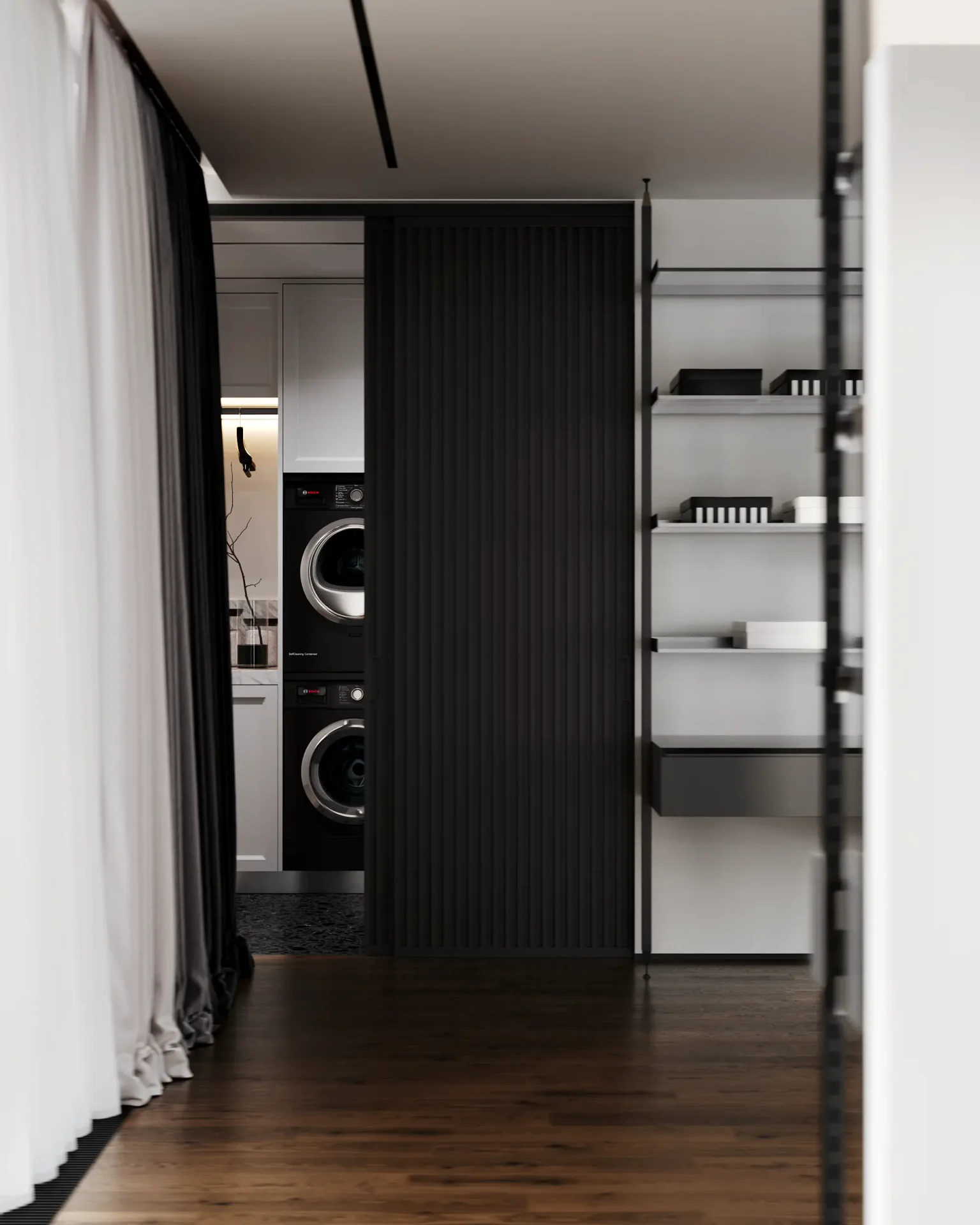 Functional laundry room featuring a washer, dryer, and wardrobe storage section.