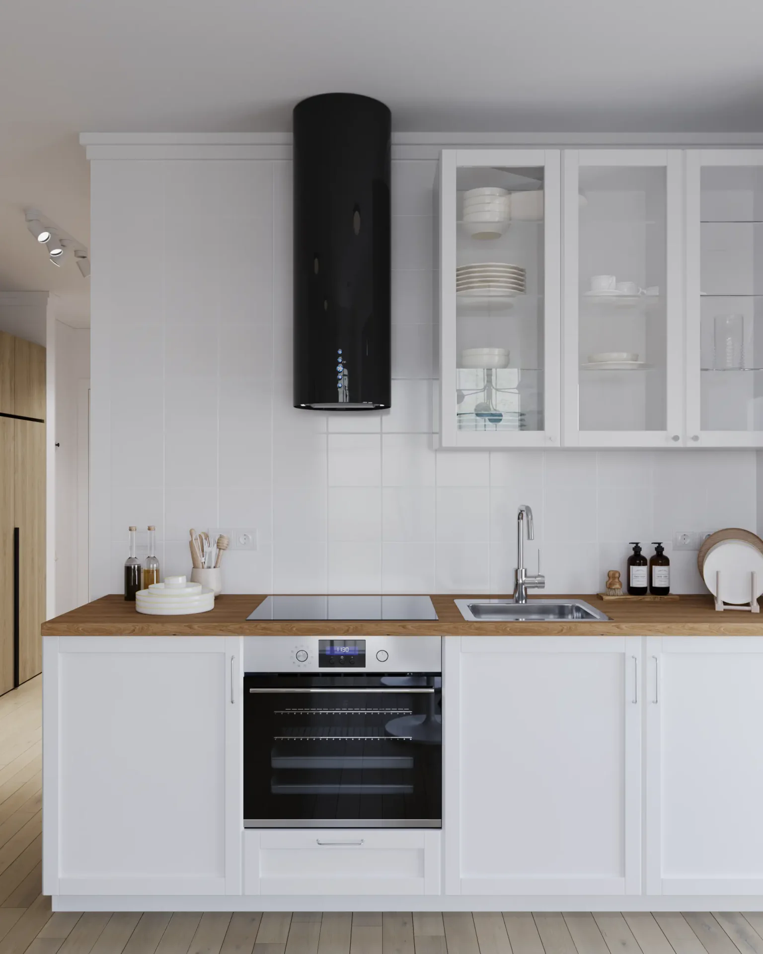 View of kitchen cabinetry, oven, hood, and cooktop.