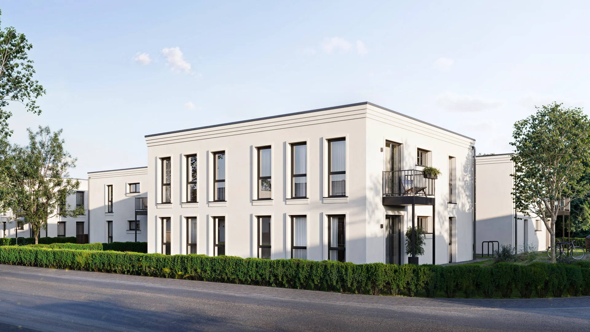Rear facade view of modern residential townhouses showing private backyards.