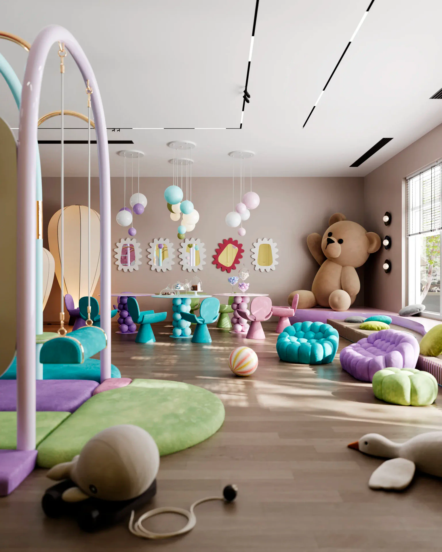 Spacious soft play zone in a children's center, featuring a climbing wall, colorful toys, and soft armchairs.