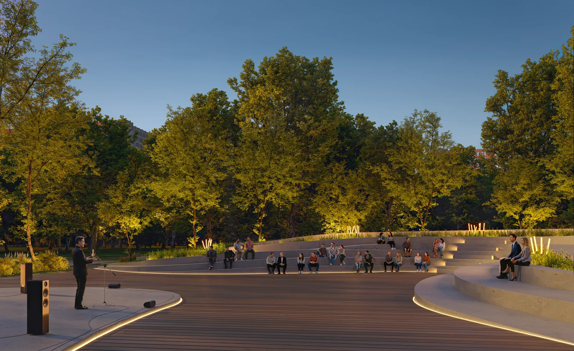 Open-air amphitheater with an audience listening to musicians performing on stage.