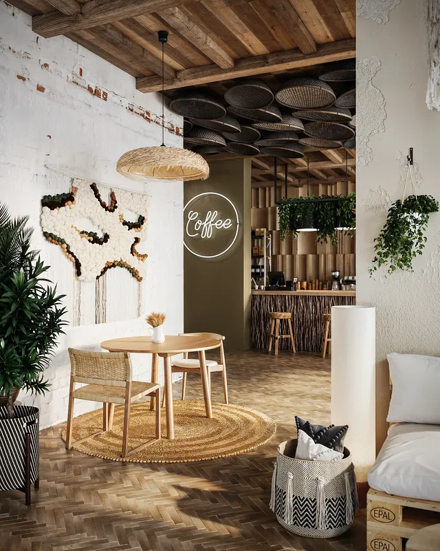 Gemütlicher Tisch für zwei Personen in einem stilvollen Durchgang, der zur Hauptbar und Kaffeestation führt.