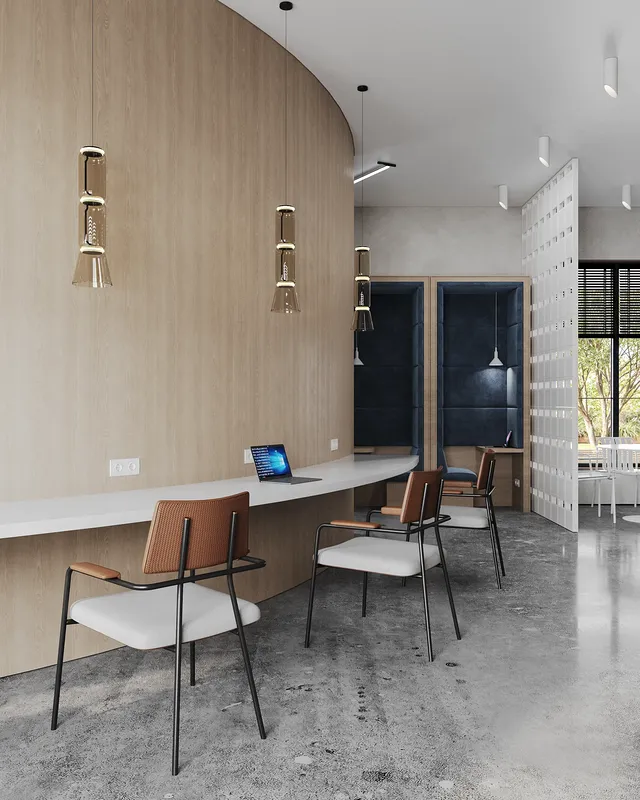 Espace de travail ouvert combinant des bureaux chauds et des cabines privées pour deux personnes avec revêtement bleu.