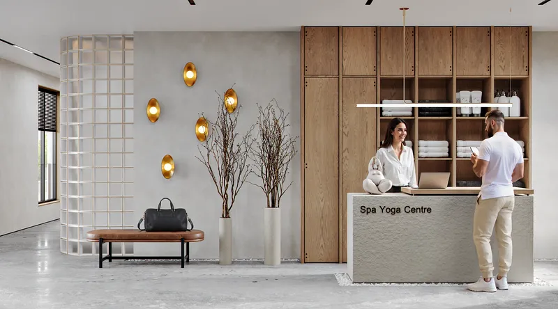 Empfangs- und Wartelounge des Wellnesscenters mit Couch, Regalen und Zugang zum Flur.