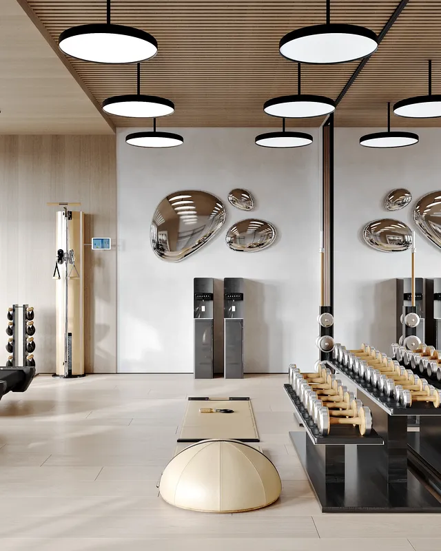 Blick auf die Wasserstation des Fitnessstudios, den Hantelständer und ein nahegelegenes Arm- und Rückengerät.