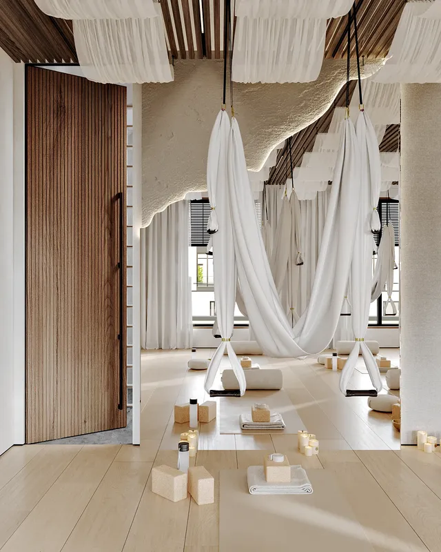 Installation de yoga aérien avec un hamac près d'un miroir, près de l'entrée des vestiaires.