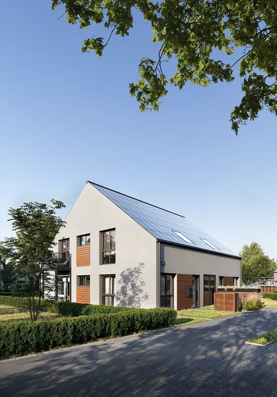 Vue en angle des façades de maisons à deux étages.
