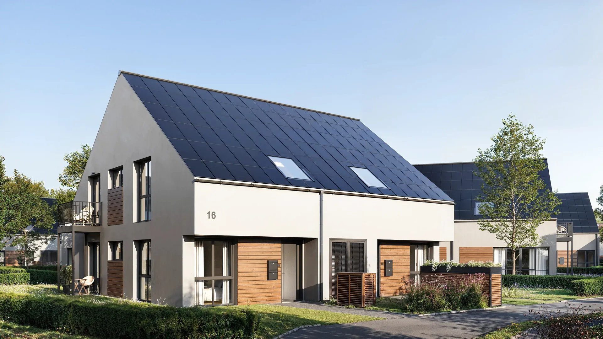 Vue en angle des façades de maisons à deux étages et des groupes d'entrée.