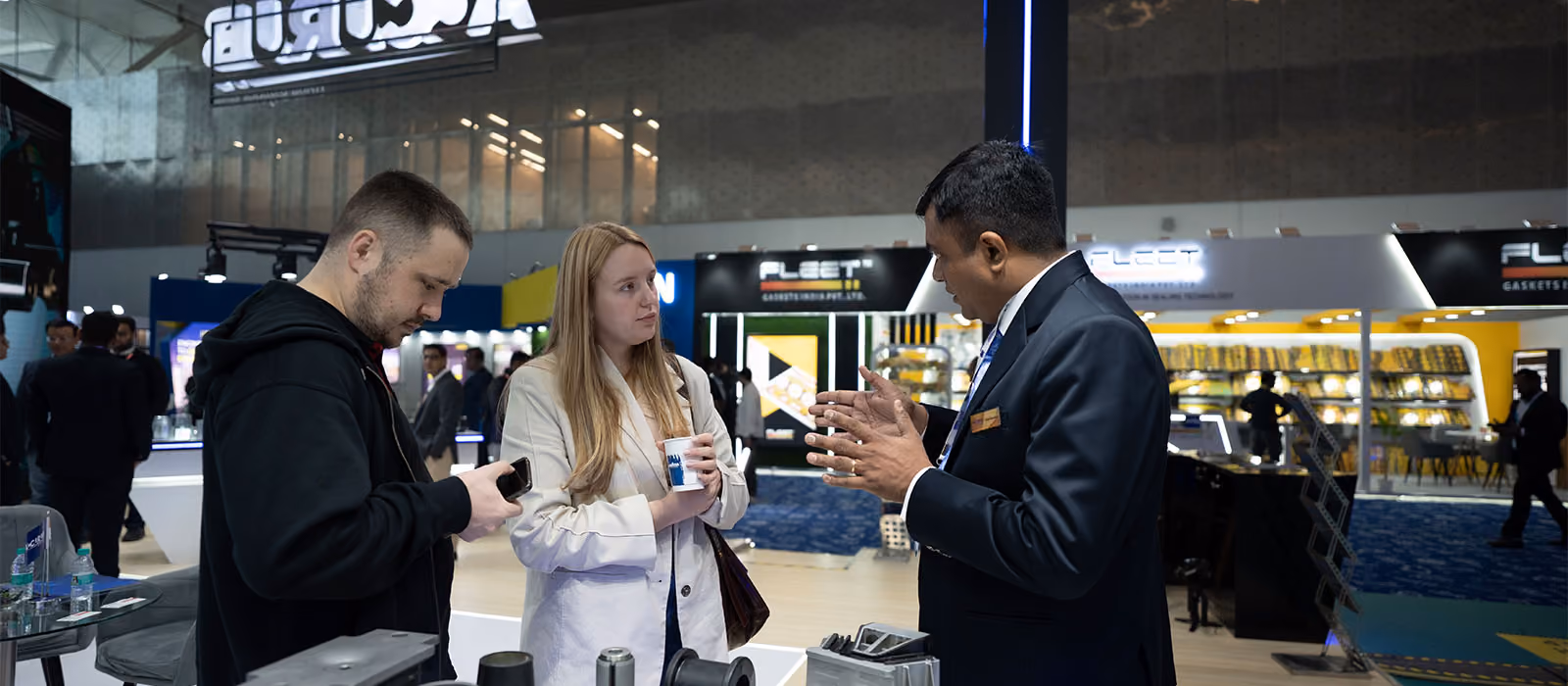 Attendees networking over brochures at a corporate event managed by Blues N Coppers