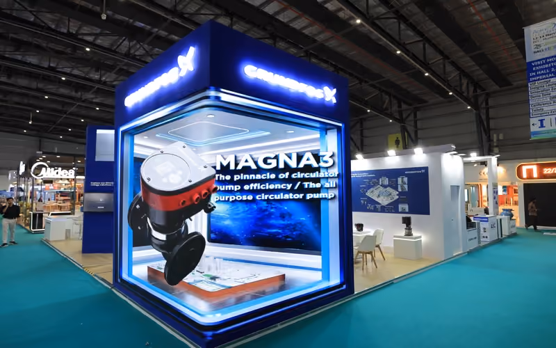 Exhibition stand with dark blue branding, designed by Blues N Coppers