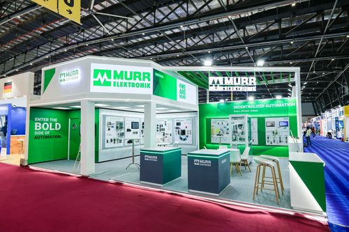 Murr Elektronik exhibition stand by Blues N Coppers, with green branding, product wall displays, and a meeting area
