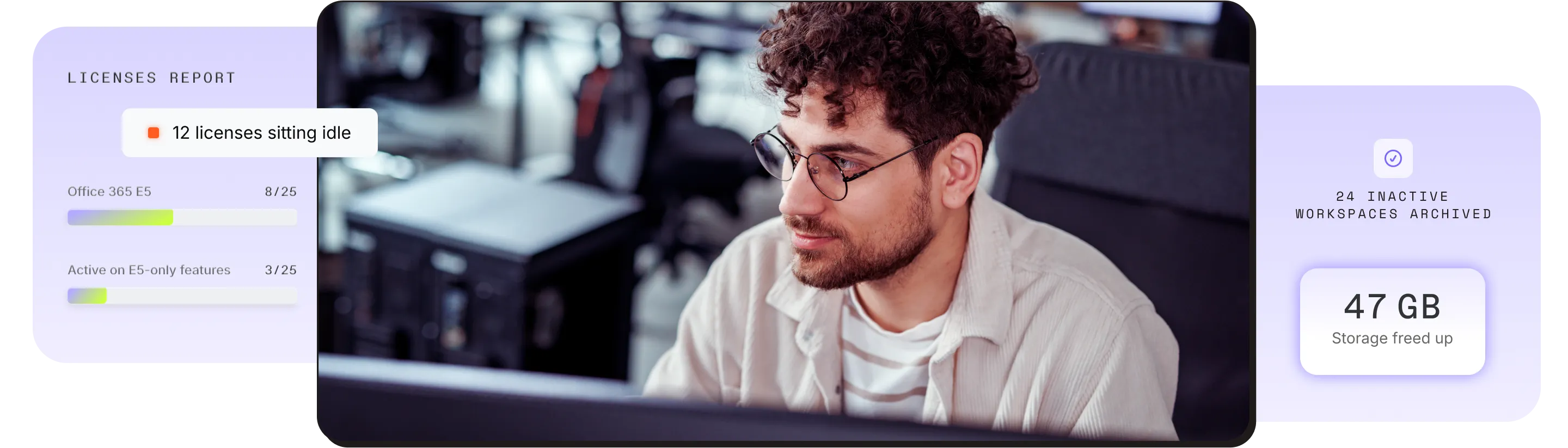 IT professional with glasses working at a laptop in a modern office environment