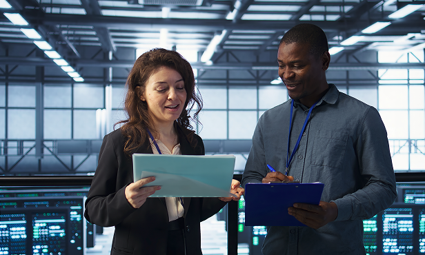 A man and a woman looking at something on a tablet.