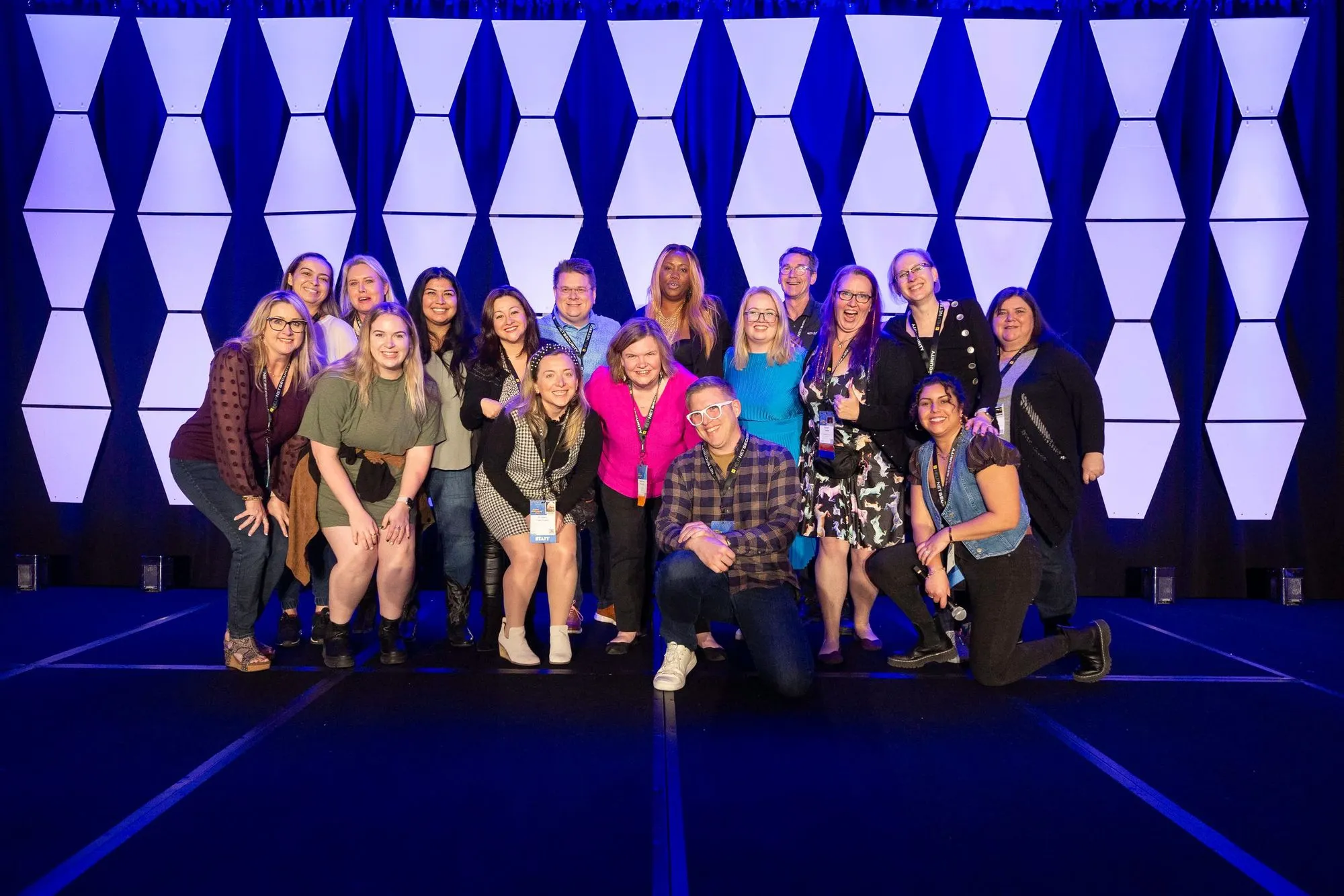 Group of 18 people smiling for photo