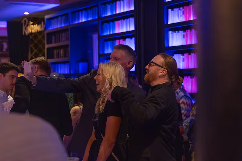 Three people looking at something in the distance and smiling