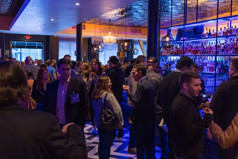 People in a bar in groups talking