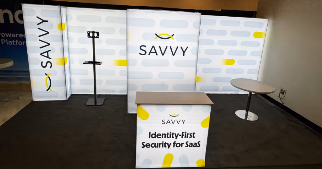 Savvy's booth the is empty besides two ables and a stand and a savvy backdrop