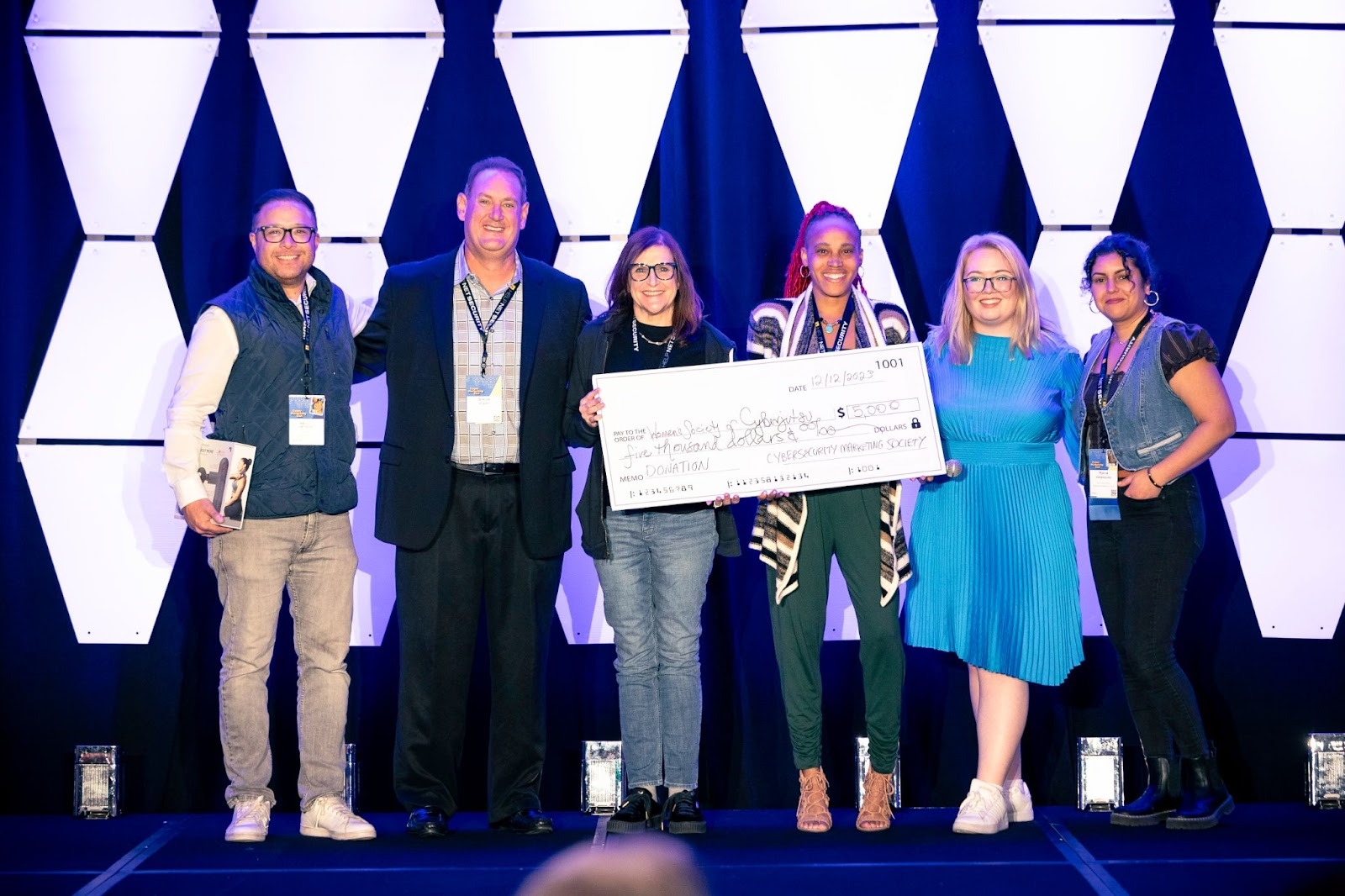 CyberEdge Group making a charitable donation at CyberMarketingCon 2023