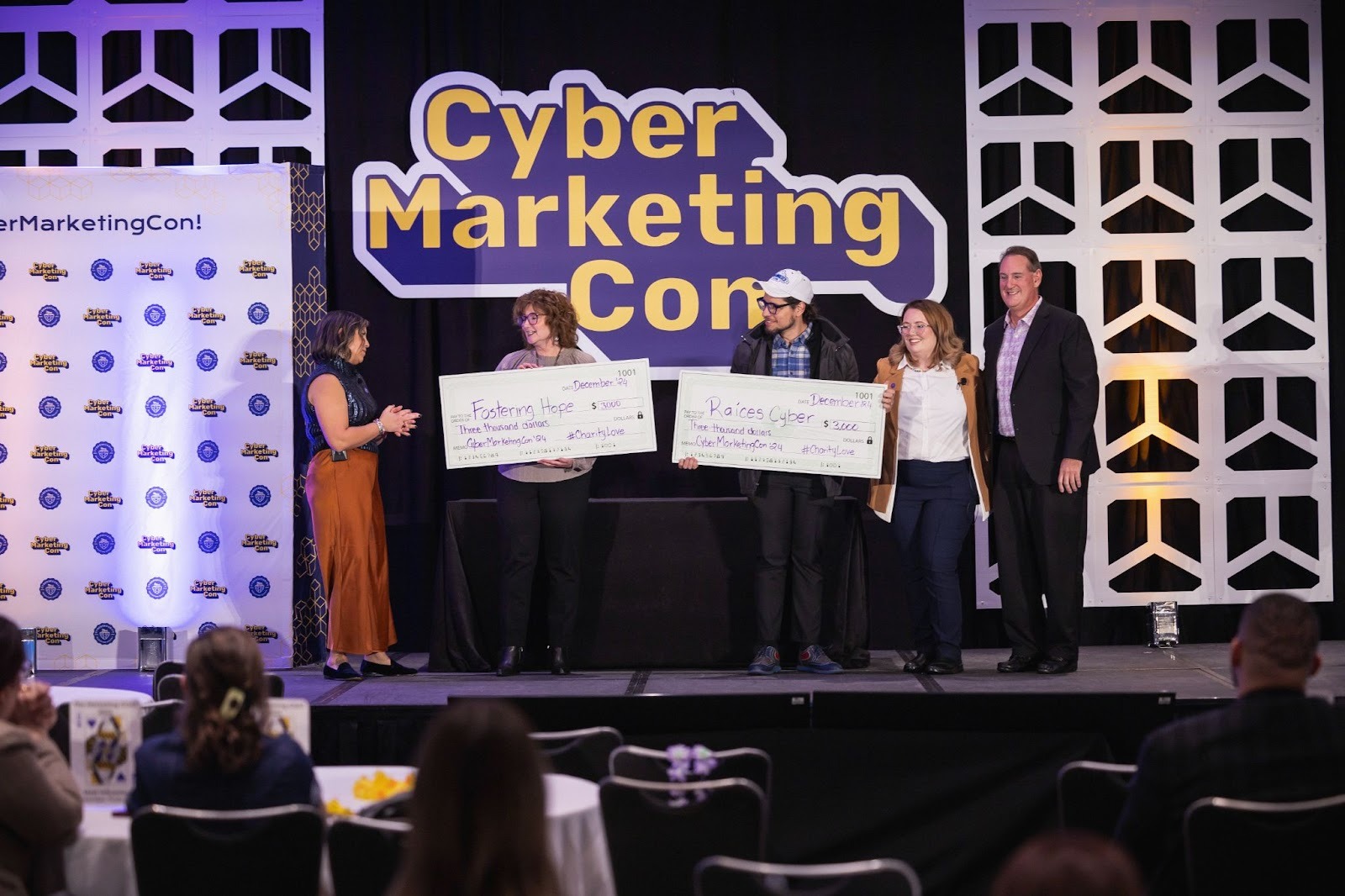CyberEdge Group making a charitable donation at CyberMarketingCon 2024