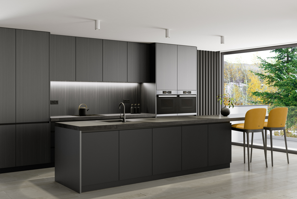 A kitchen with a sink, stove, microwave and chairs.