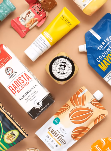 Variety of packaged food and skincare items including almond milk, almond butter, coconut mayo, and moisturizer.