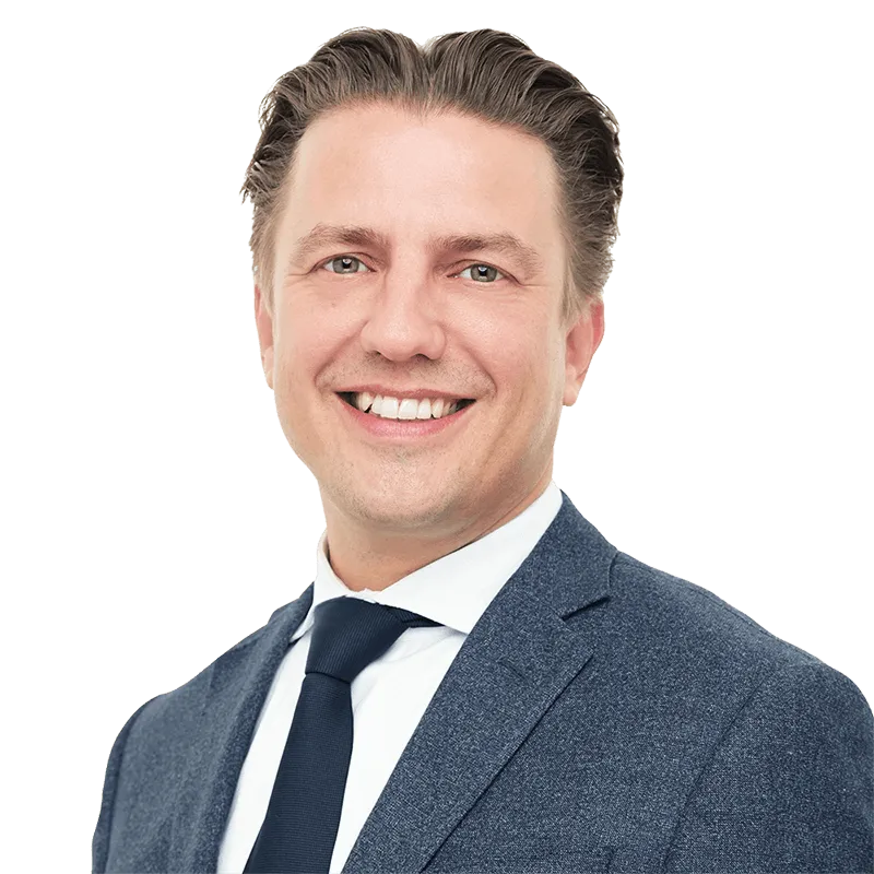 A headshot image of Jeroen Bedaux, looking towards the camera, smiling and wearing a suit and tie.