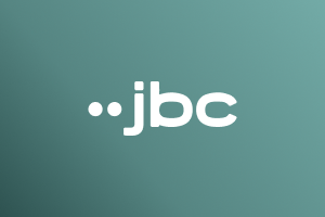 JBC logo in white on Marigold gradient background