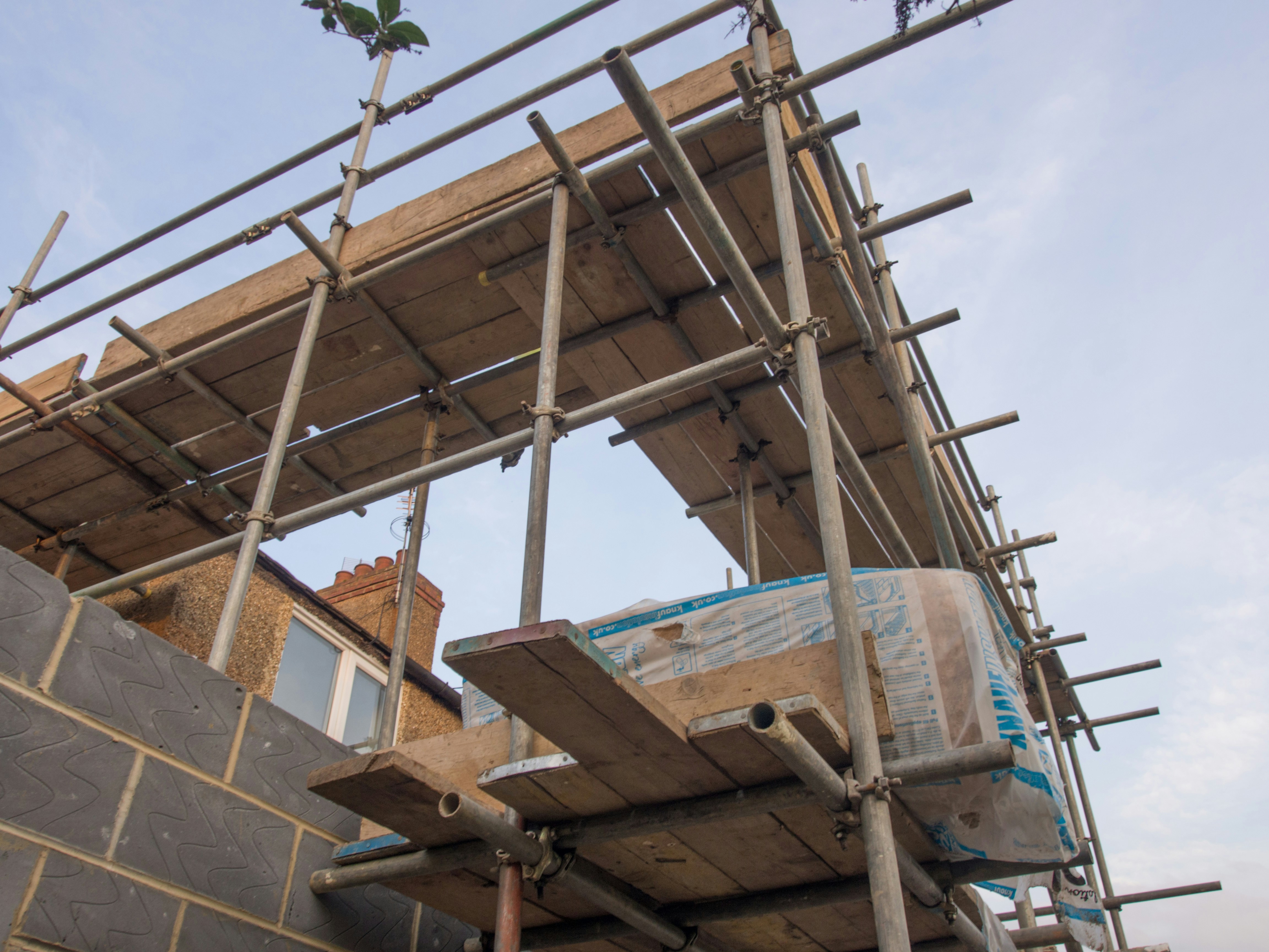 Scaffolding setup with a masonry bag at a construction site.