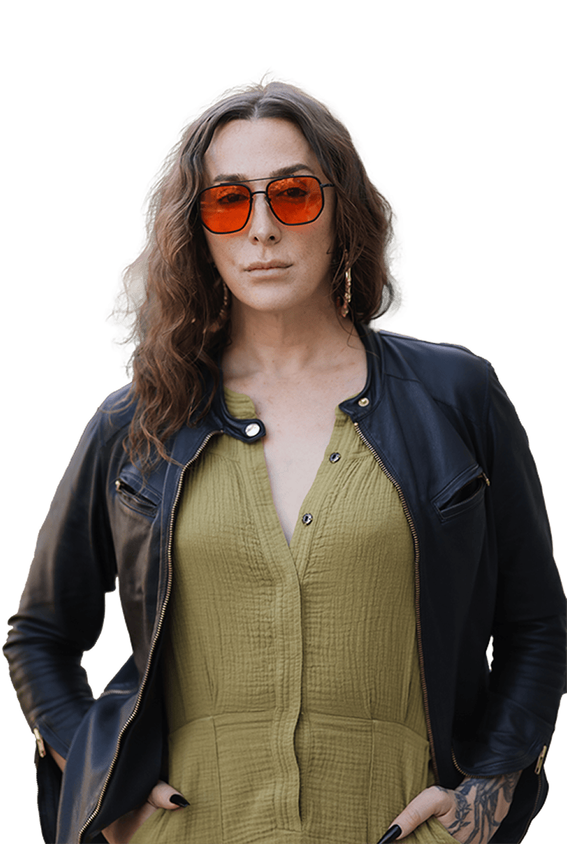 Person in orange-tinted sunglasses, leather jacket, and olive green shirt