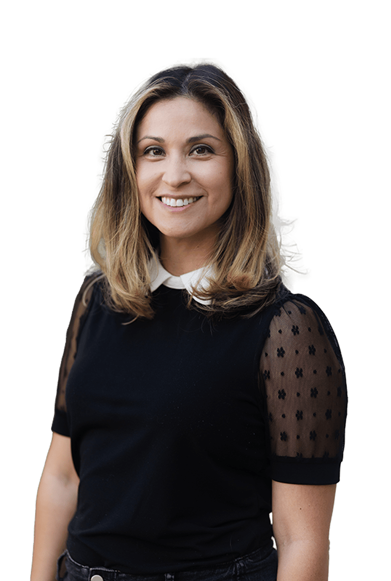 Smiling woman in black top with sheer polka dot sleeves