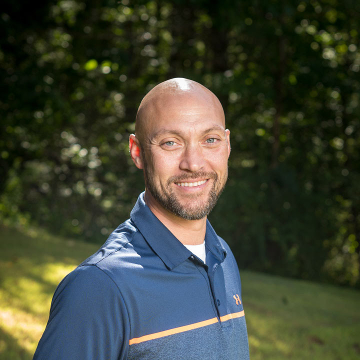 Headshot of Bill Merchant, co-founder & CEO of Revolution Fitness, smiling.