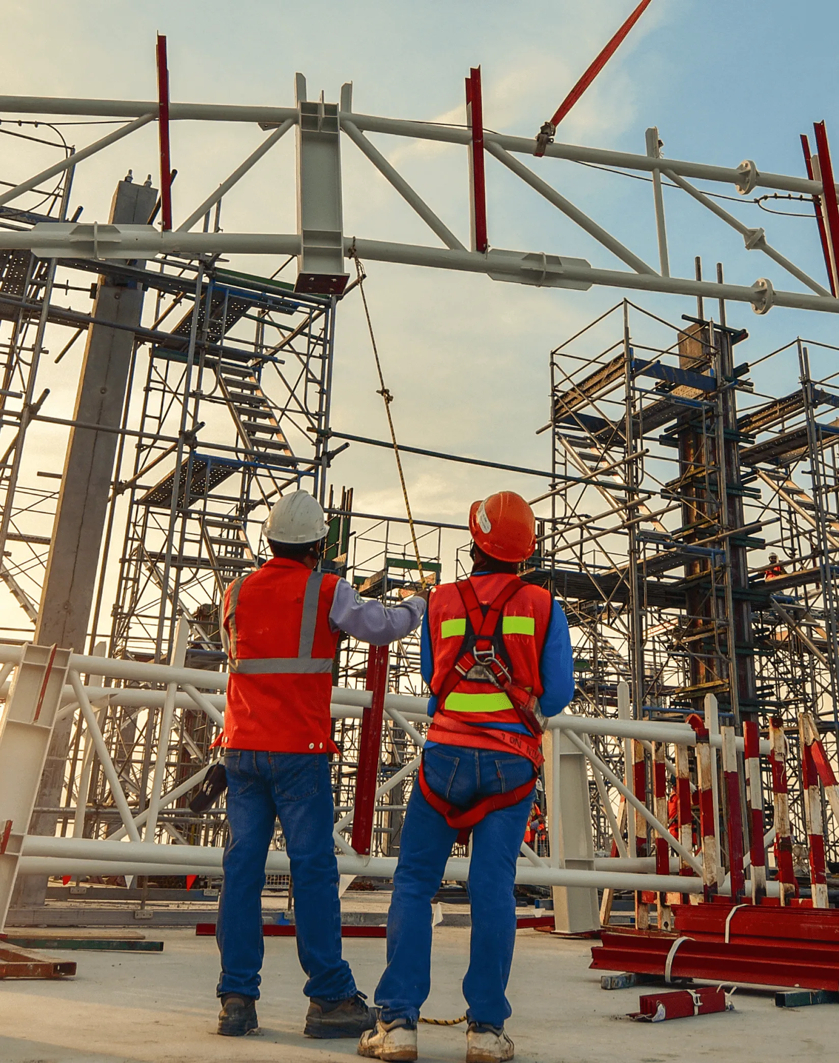 Two workers in front of construction