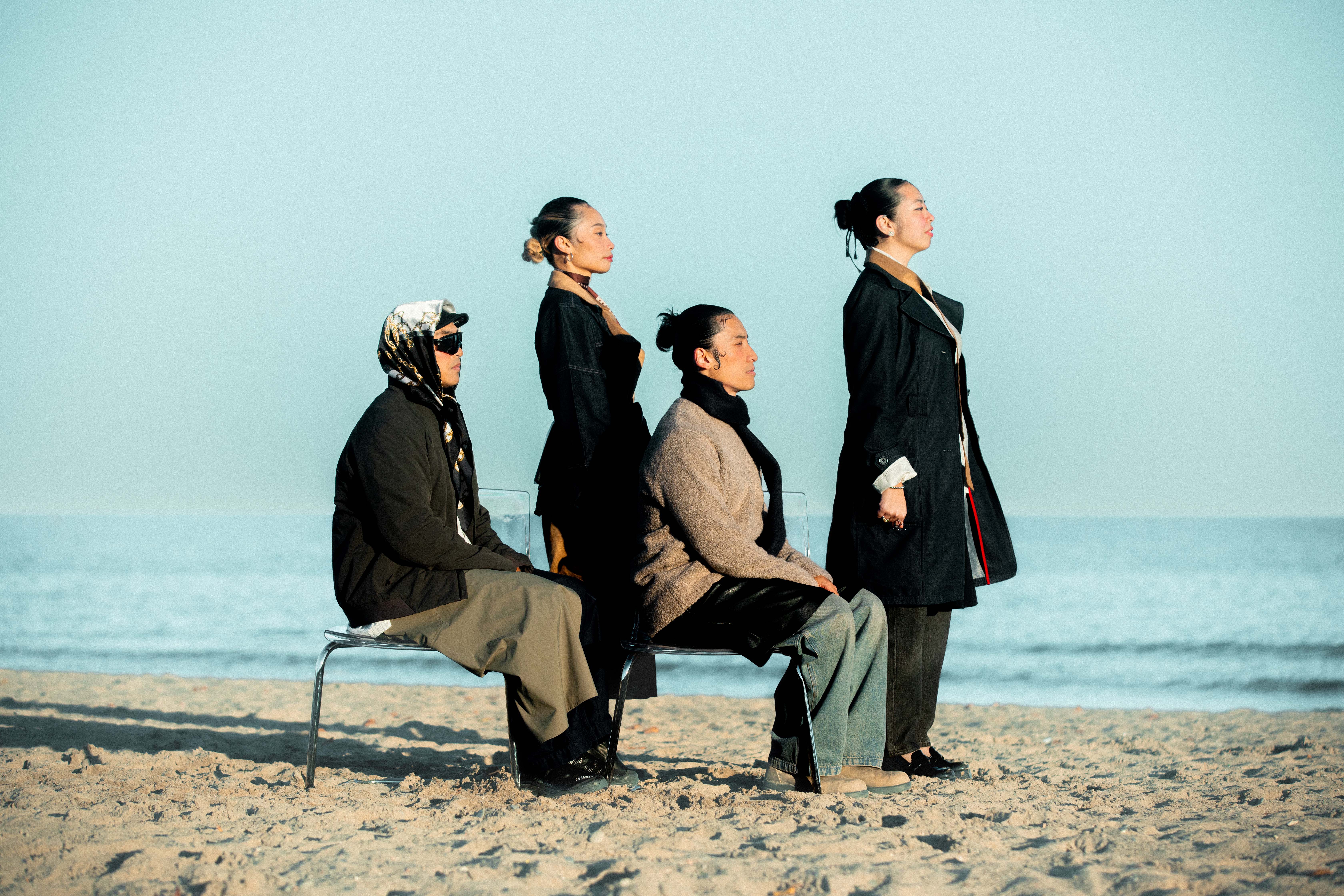 Sync&Flow members standing on the beach looking at horizon