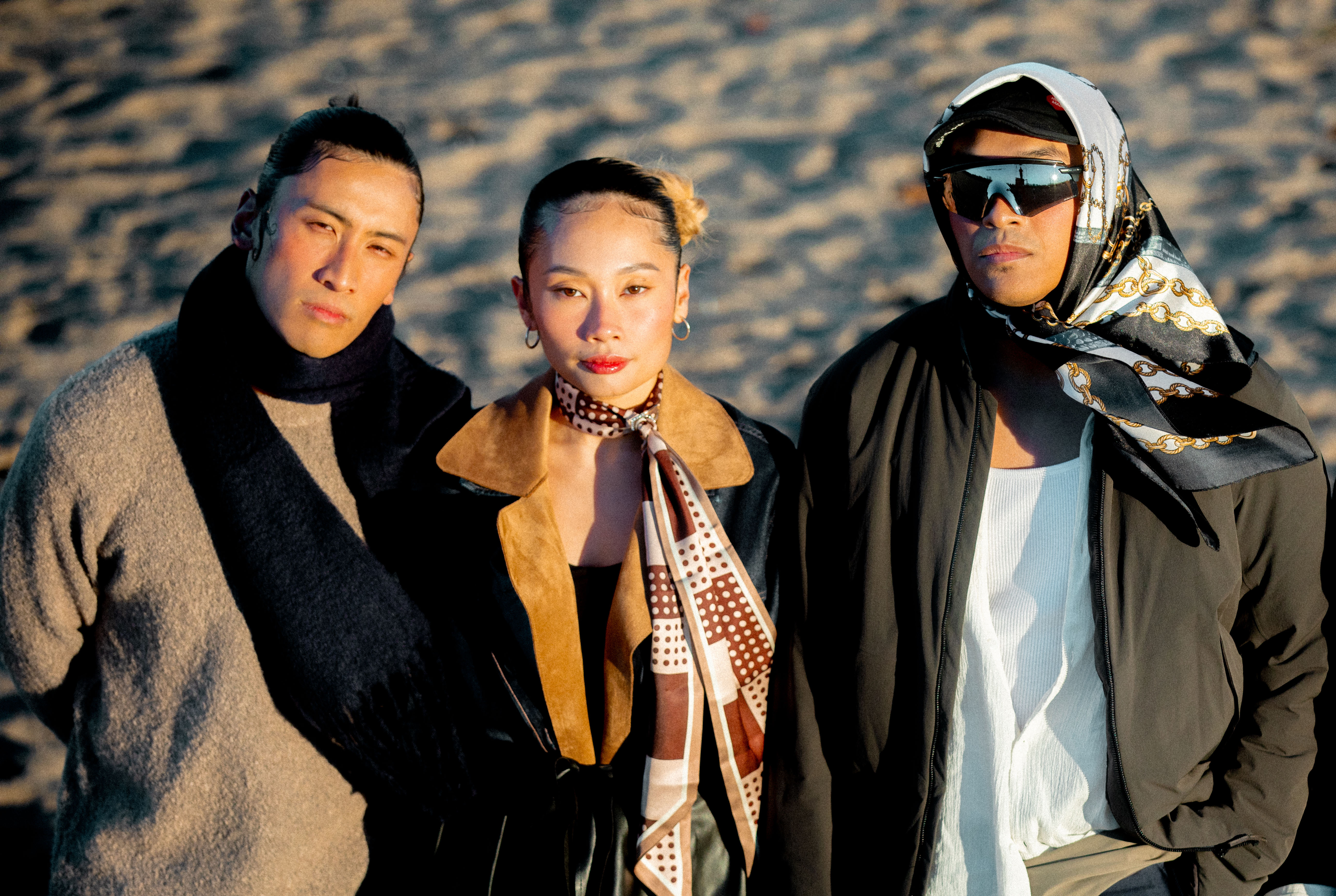 AJ Velasco, Kin Nguien, and Josh Torres standing on beach