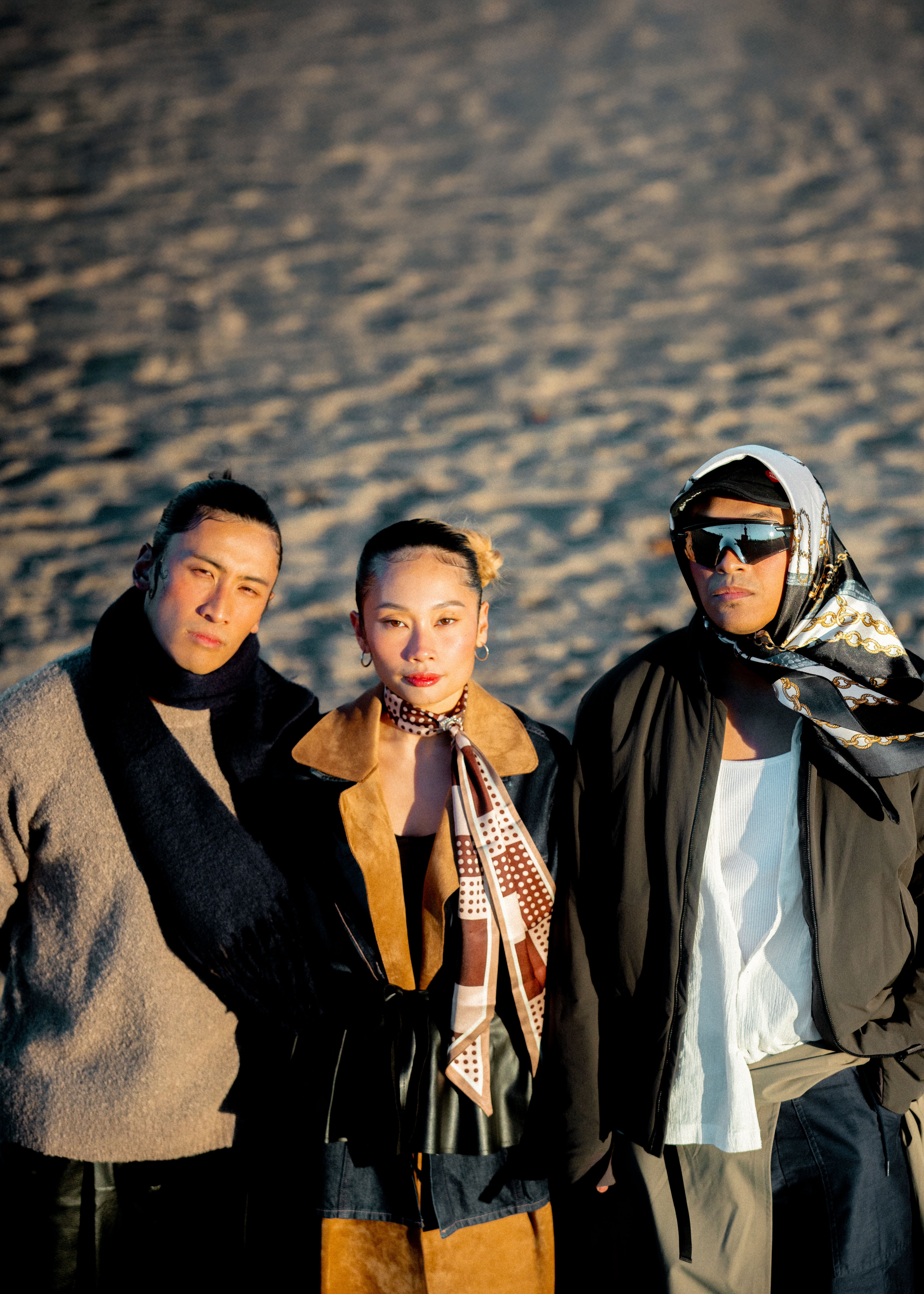 AJ Velasco, Kin Nguien, and Josh Torres standing on beach