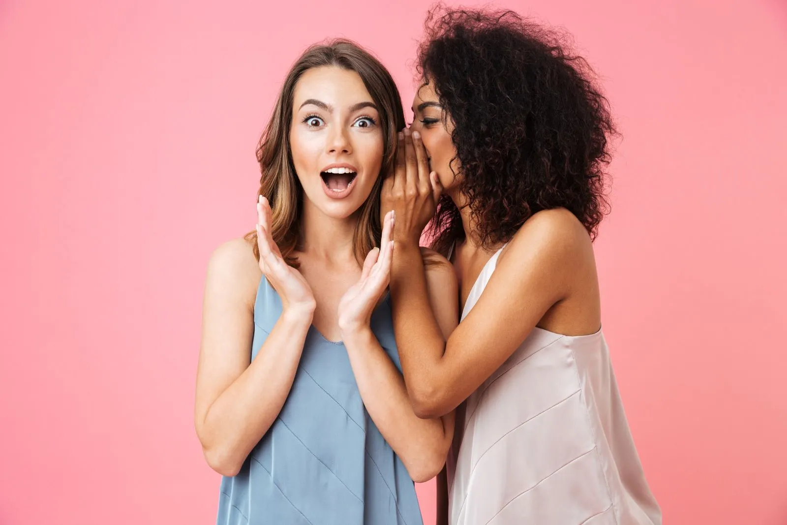 Two women standing next to each other with their mouths open.