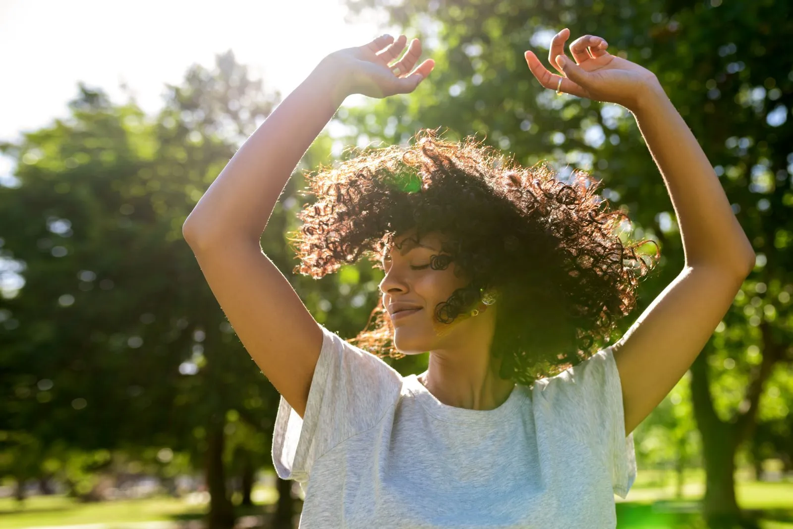 A woman with her hands up in the air.