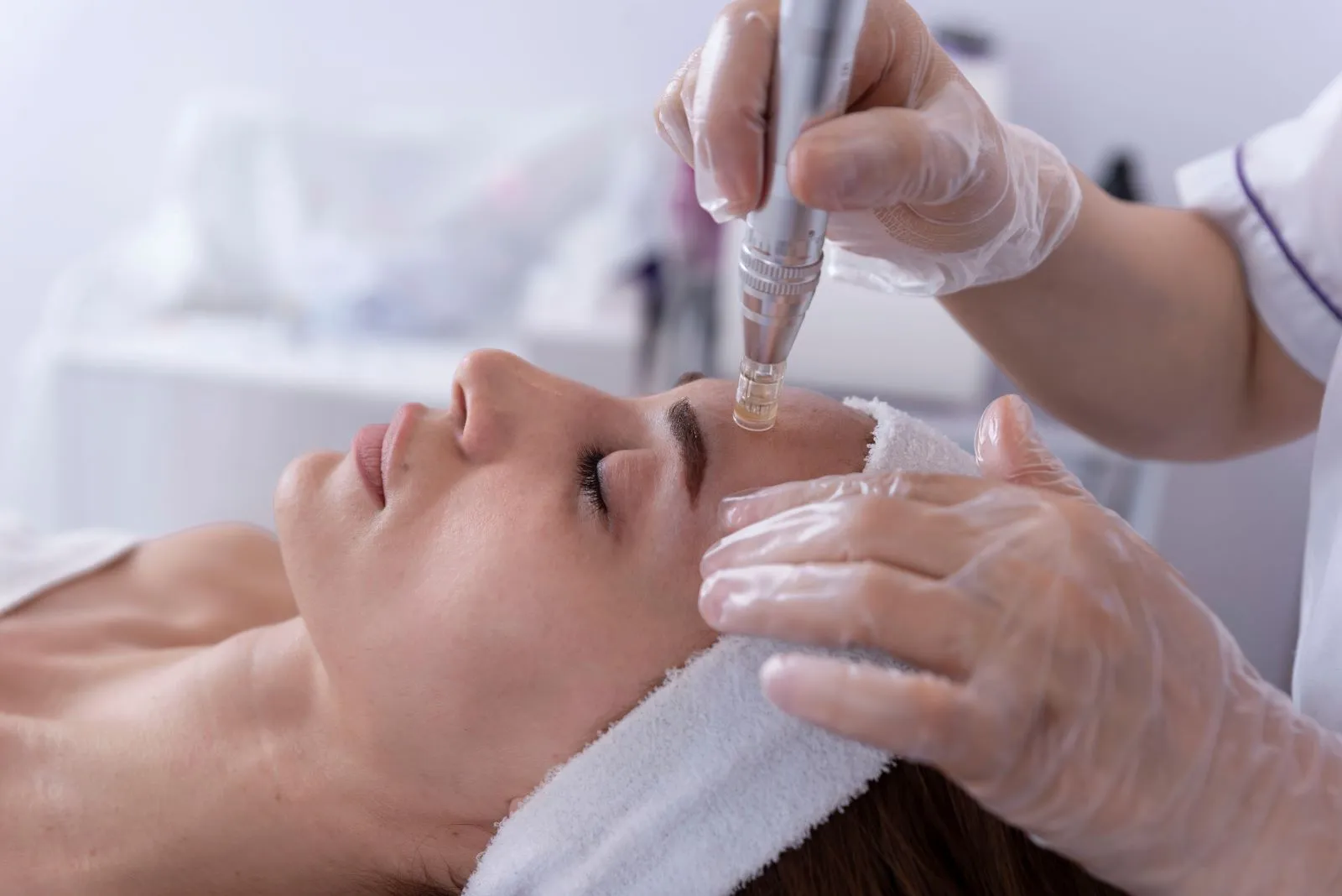 A woman getting a facial peel from a doctor.